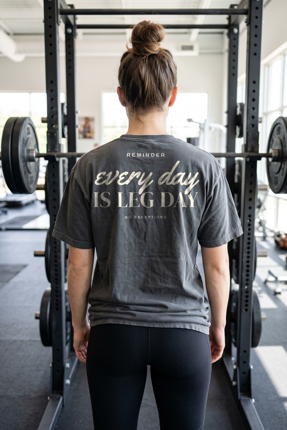 Woman at a squat rack in an Every Day Is Leg Day tee