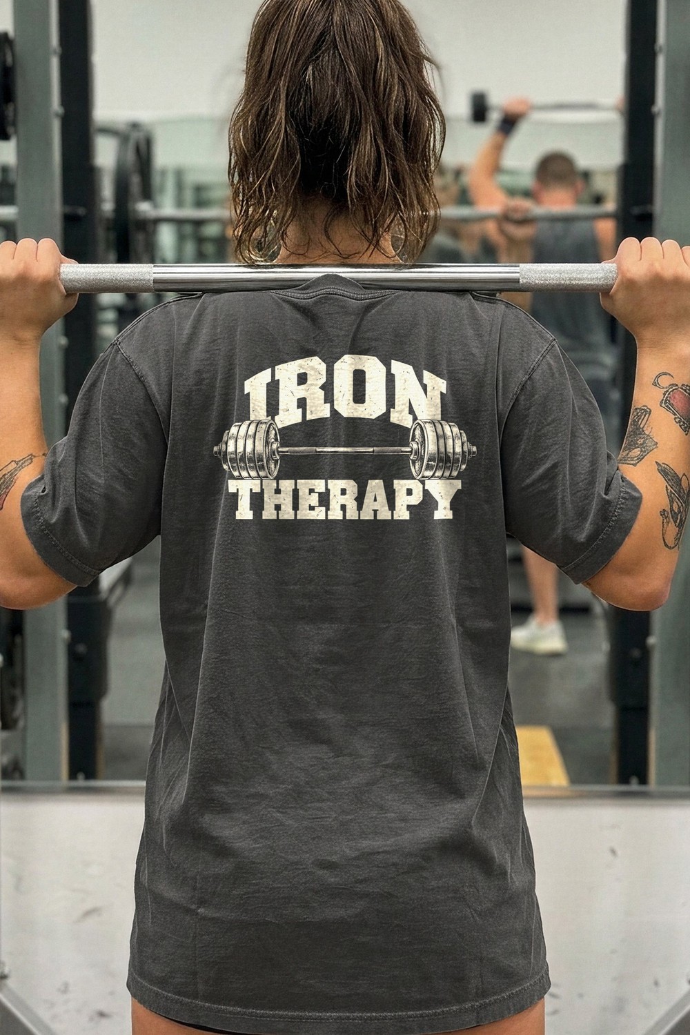 Woman at the squat rack in an Iron Therapy tee