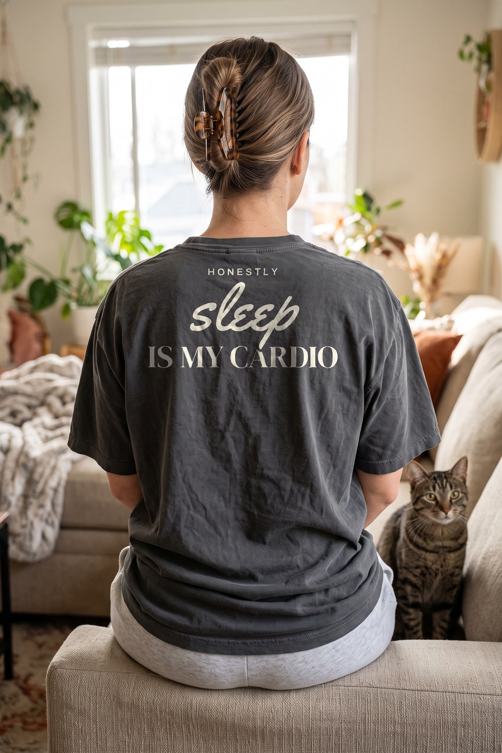 Sleep Is My Cardio oversized tee on the couch with a cat