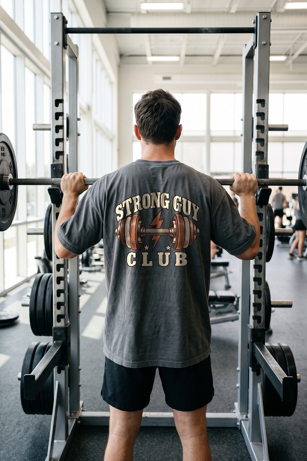 Man at the gym in a Strong Guy Club oversized tee