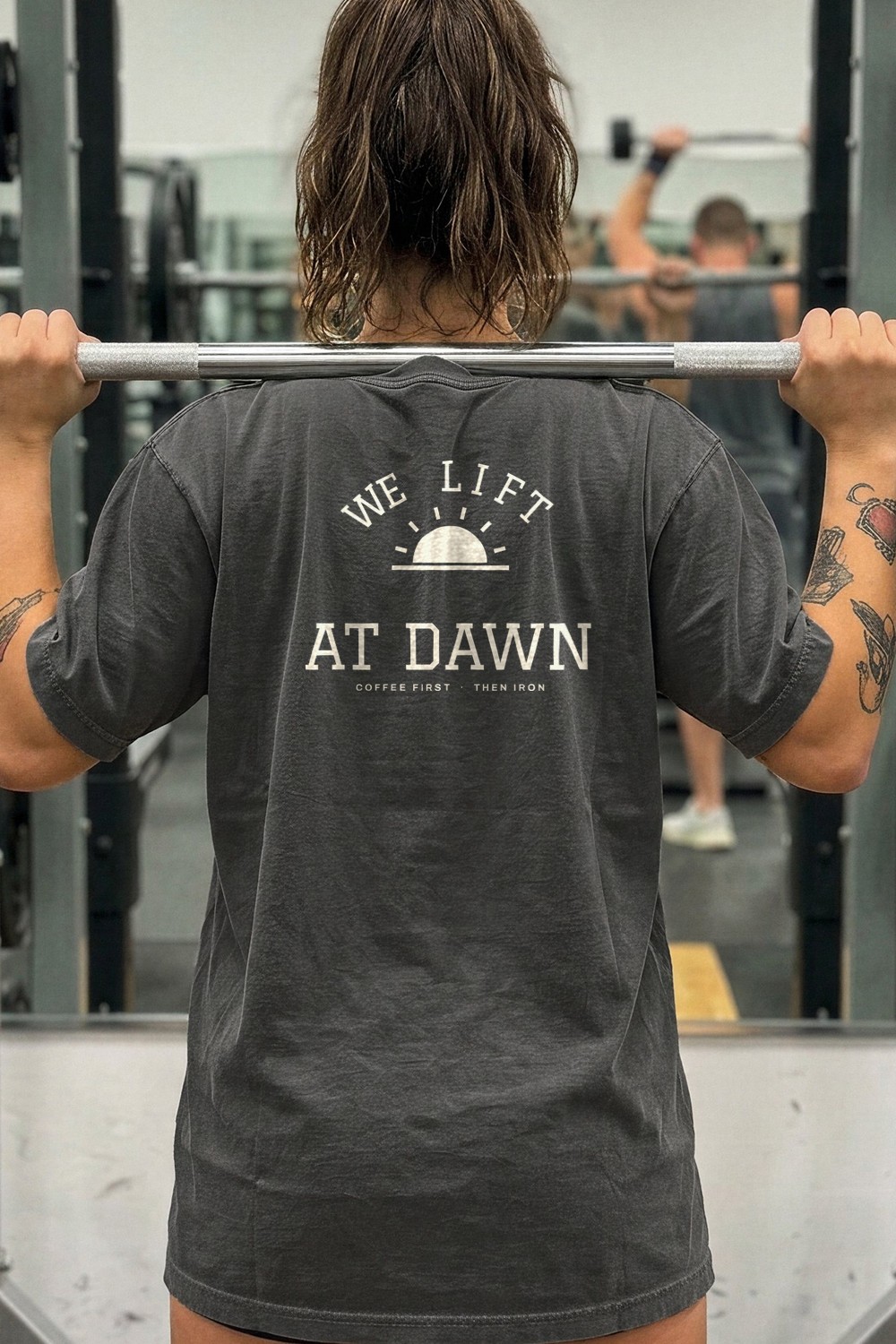 Woman at the squat rack in a We Lift at Dawn tee